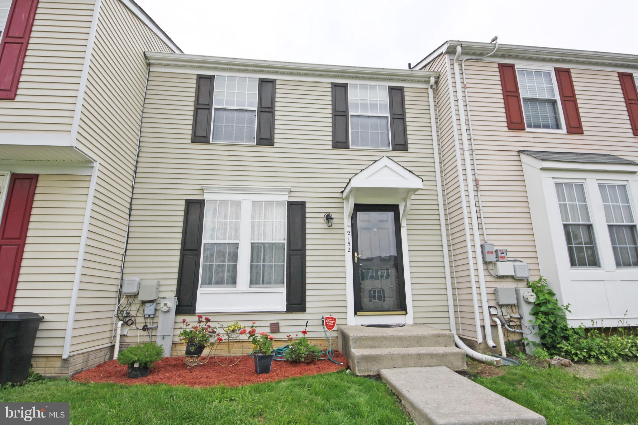 2152 Cedar Barn Way Baltimore, MD 21244 - Photo 1 of 29 a front view of a house with a yard and garage
