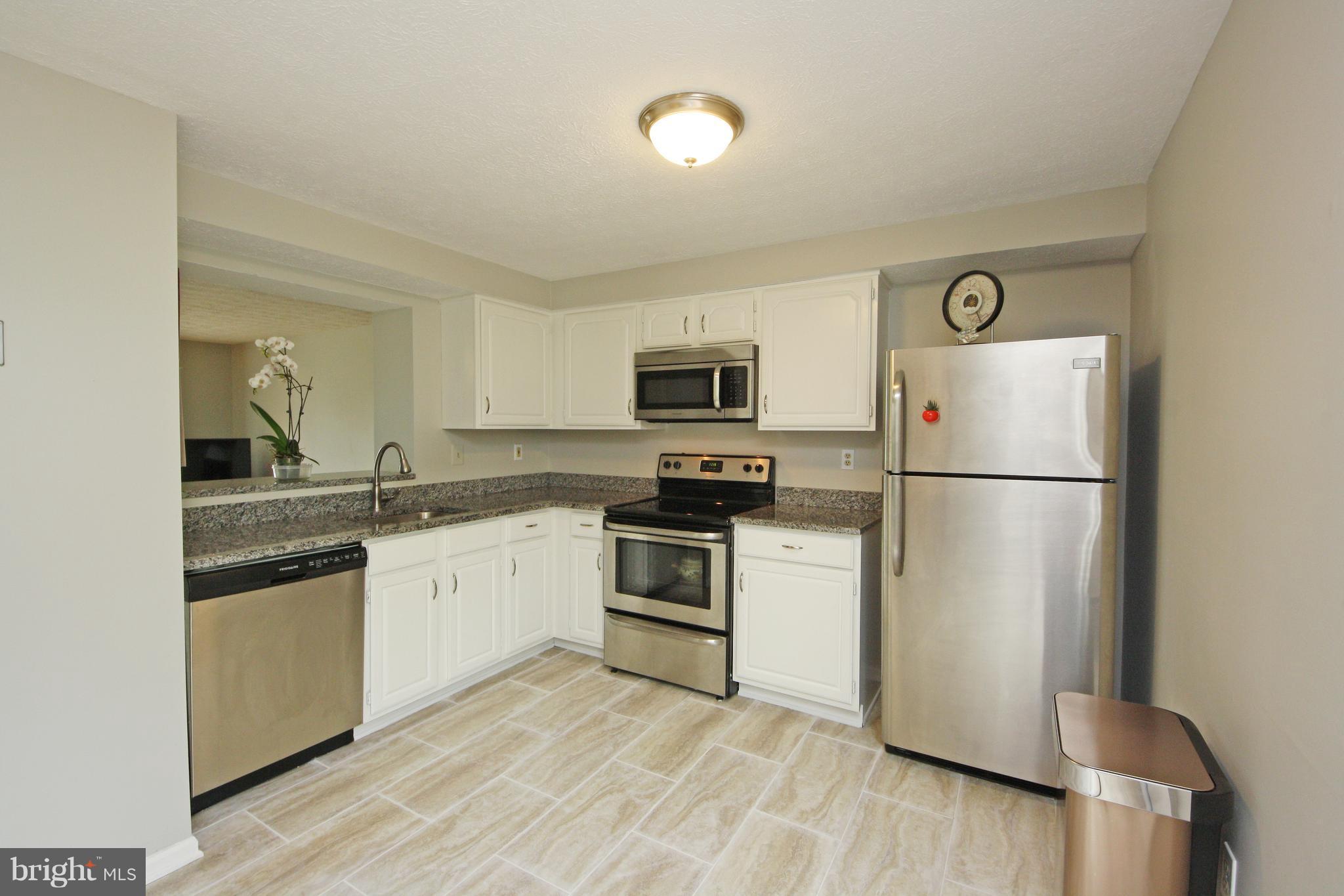 2152 Cedar Barn Way Baltimore, MD 21244 - Photo 2 of 29 a kitchen with granite countertop a refrigerator stove and sink