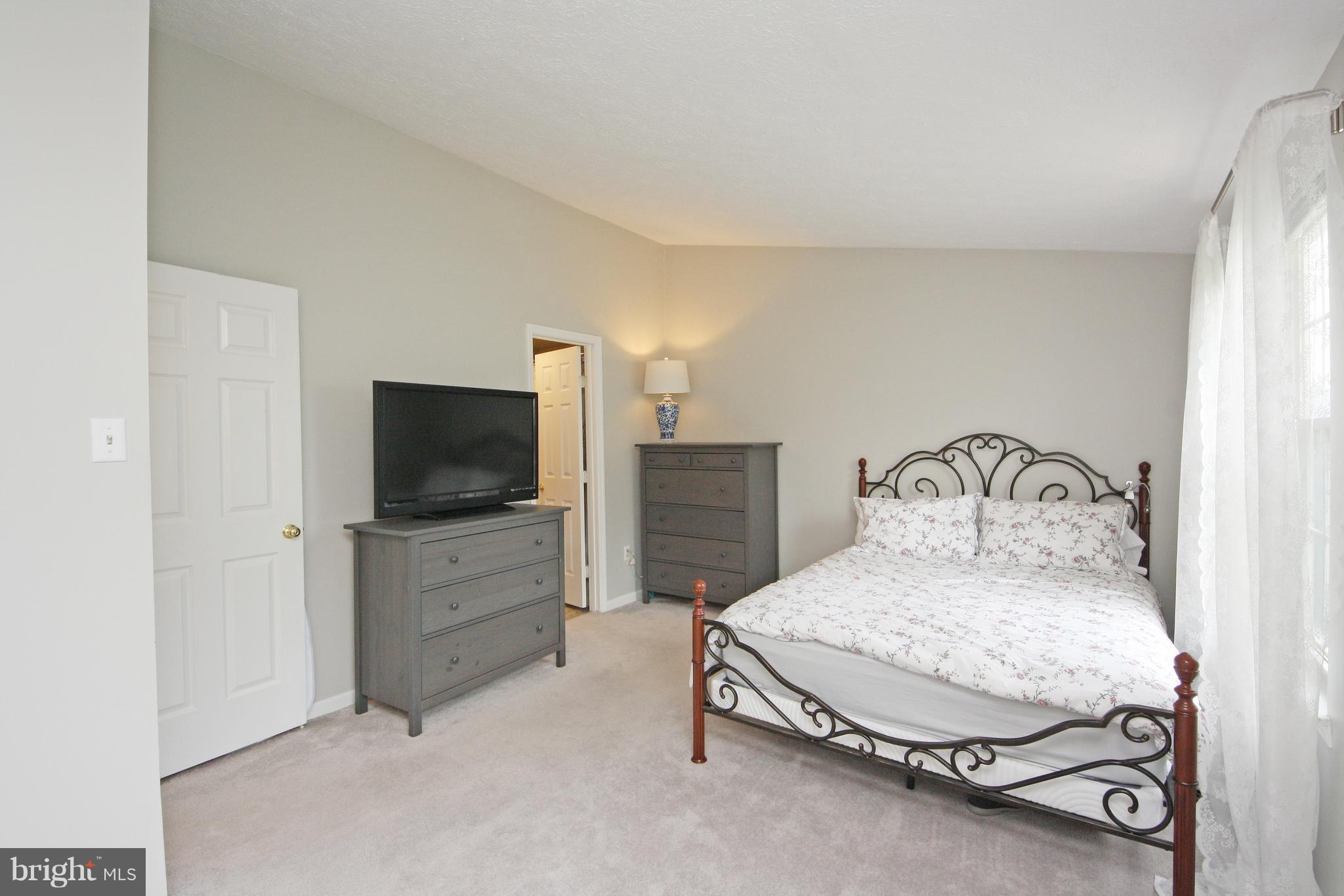 2152 Cedar Barn Way Baltimore, MD 21244 - Photo 11 of 29 a bedroom with a bed and a flat screen tv