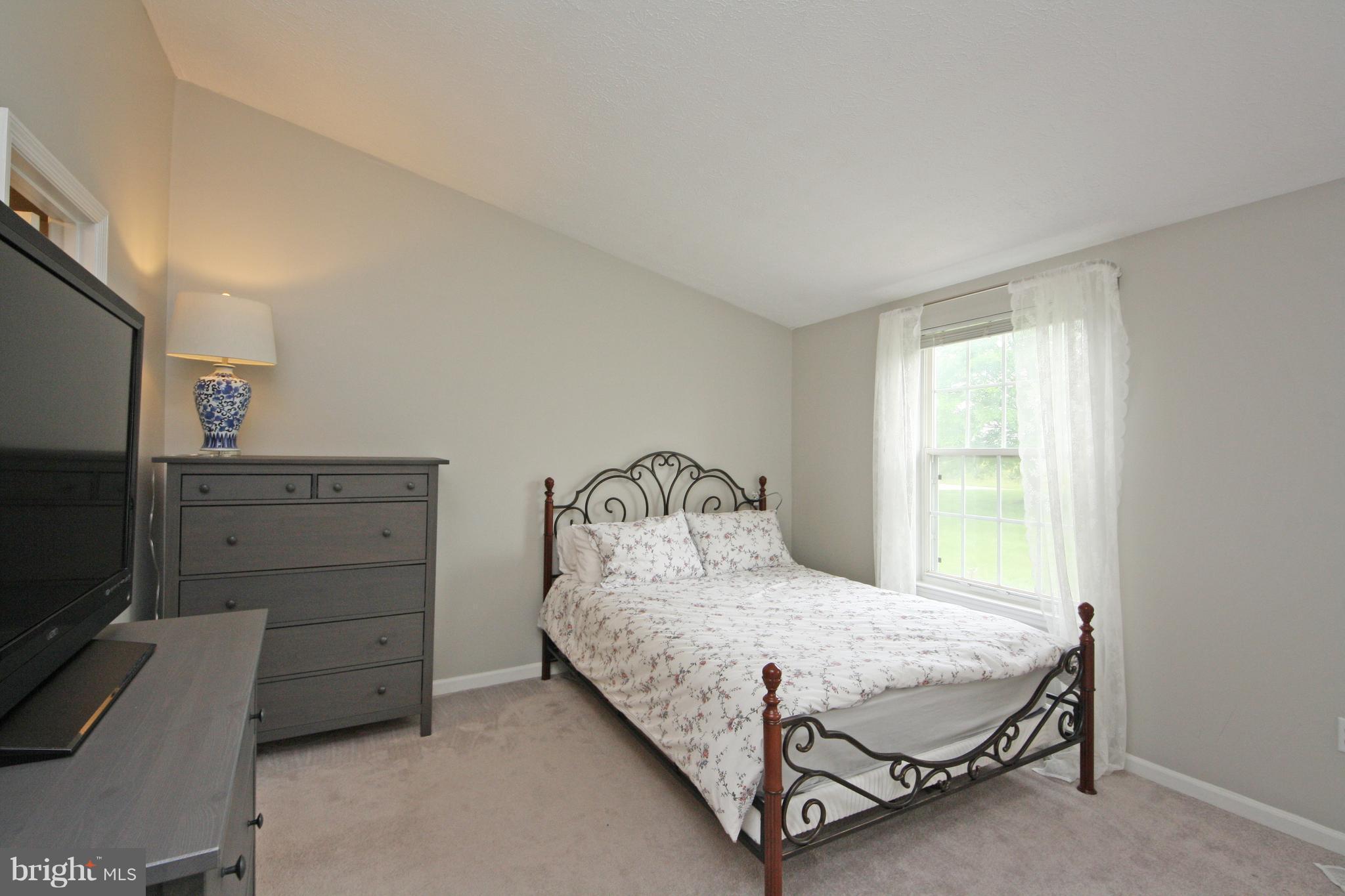 2152 Cedar Barn Way Baltimore, MD 21244 - Photo 13 of 29 a bedroom with a bed and a television