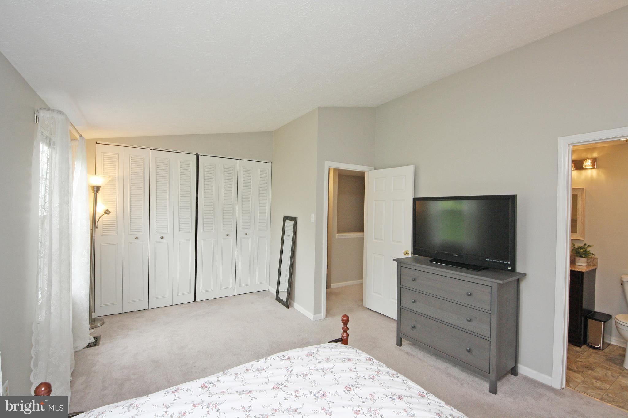 2152 Cedar Barn Way Baltimore, MD 21244 - Photo 14 of 29 a living room with flat screen tv on dresser and a wooden floor