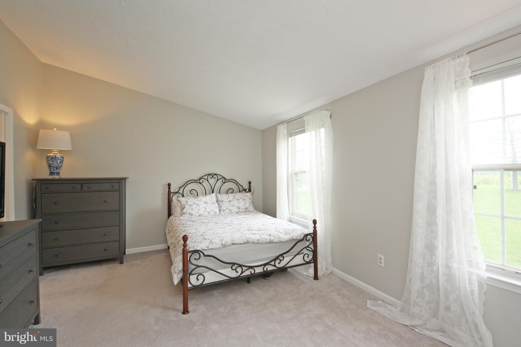 2152 Cedar Barn Way Baltimore, MD 21244 - Photo 16 of 29 a bedroom with a bed and a dresser