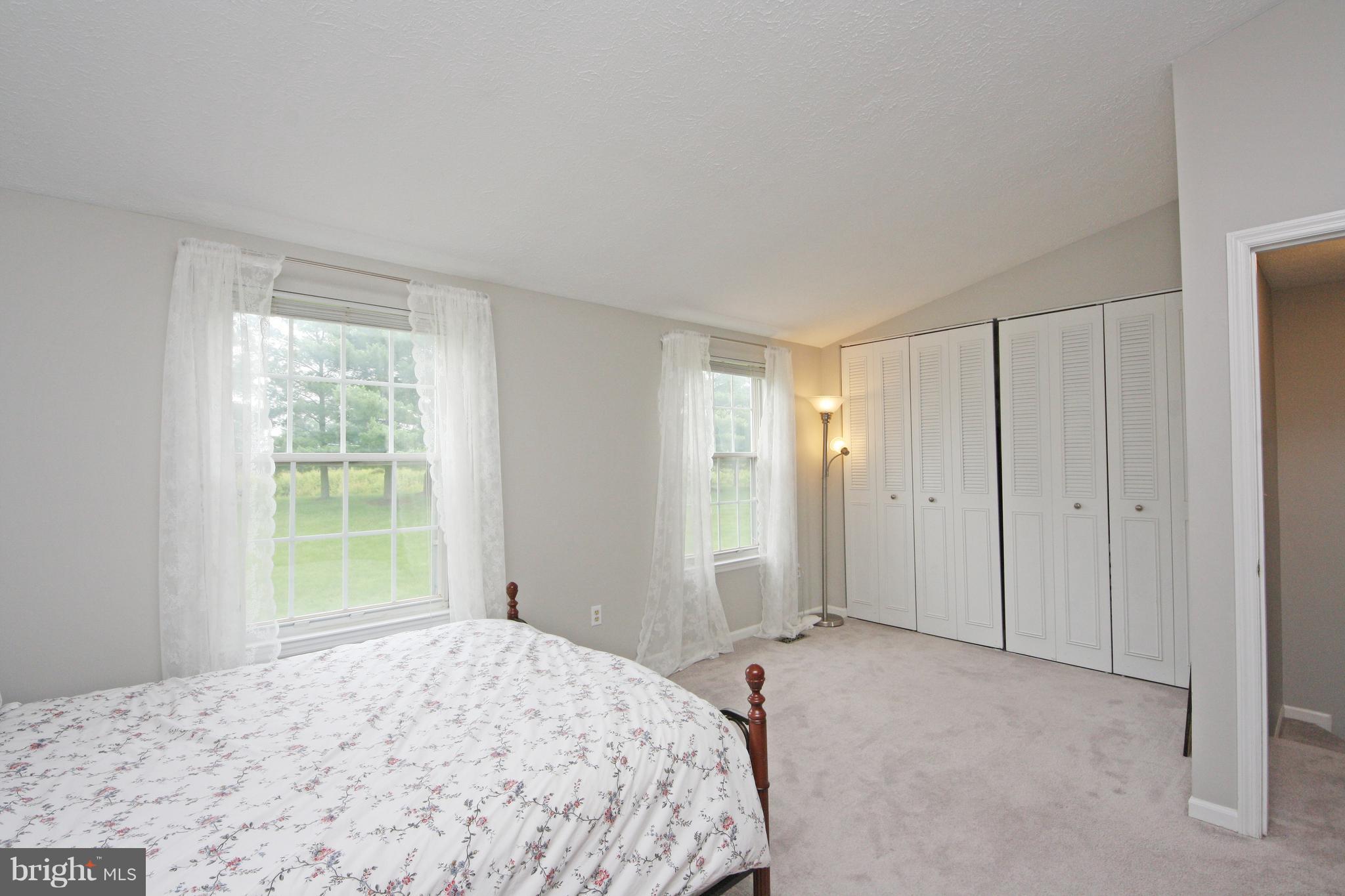 2152 Cedar Barn Way Baltimore, MD 21244 - Photo 17 of 29 a bedroom with a bed and a window