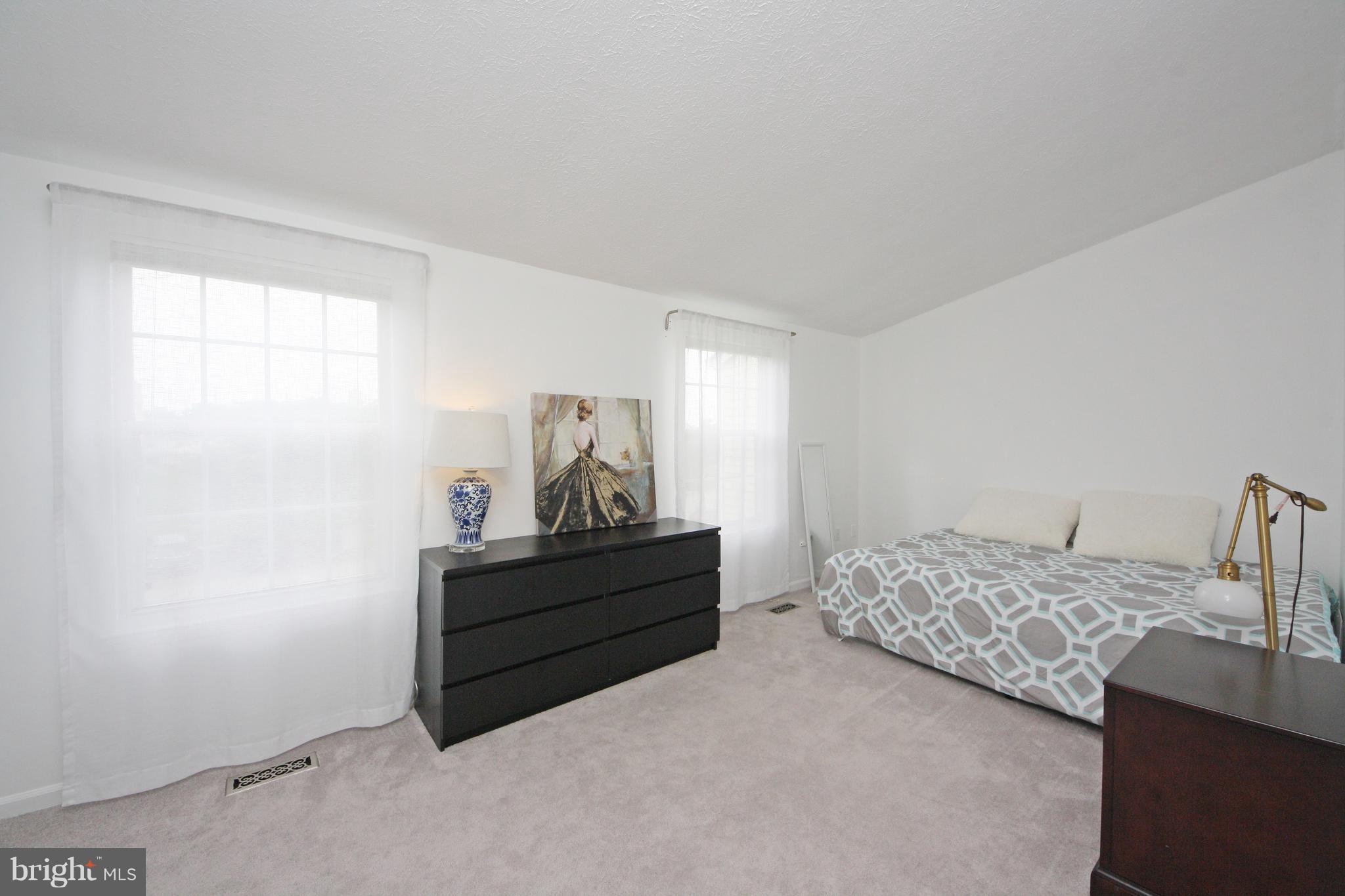 2152 Cedar Barn Way Baltimore, MD 21244 - Photo 19 of 29 a bedroom with a bed and a dresser