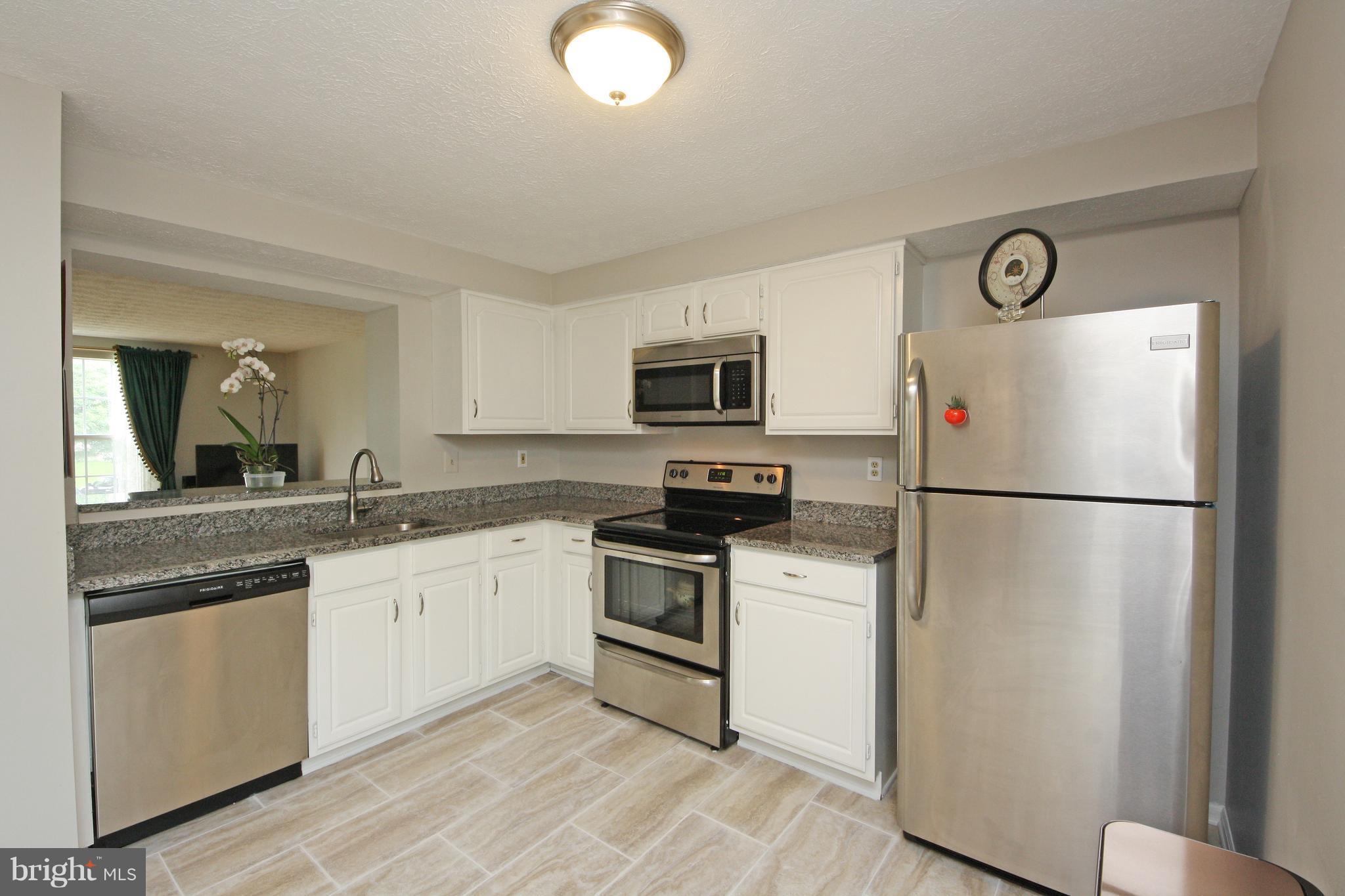 2152 Cedar Barn Way Baltimore, MD 21244 - Photo 3 of 29 a kitchen with a refrigerator sink and stove