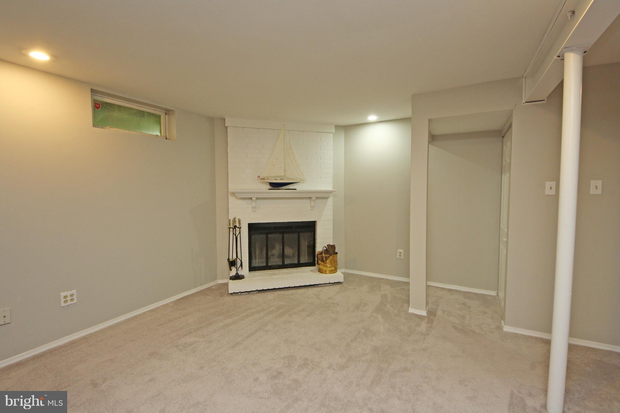2152 Cedar Barn Way Baltimore, MD 21244 - Photo 23 of 29 a view of an empty room with a fireplace