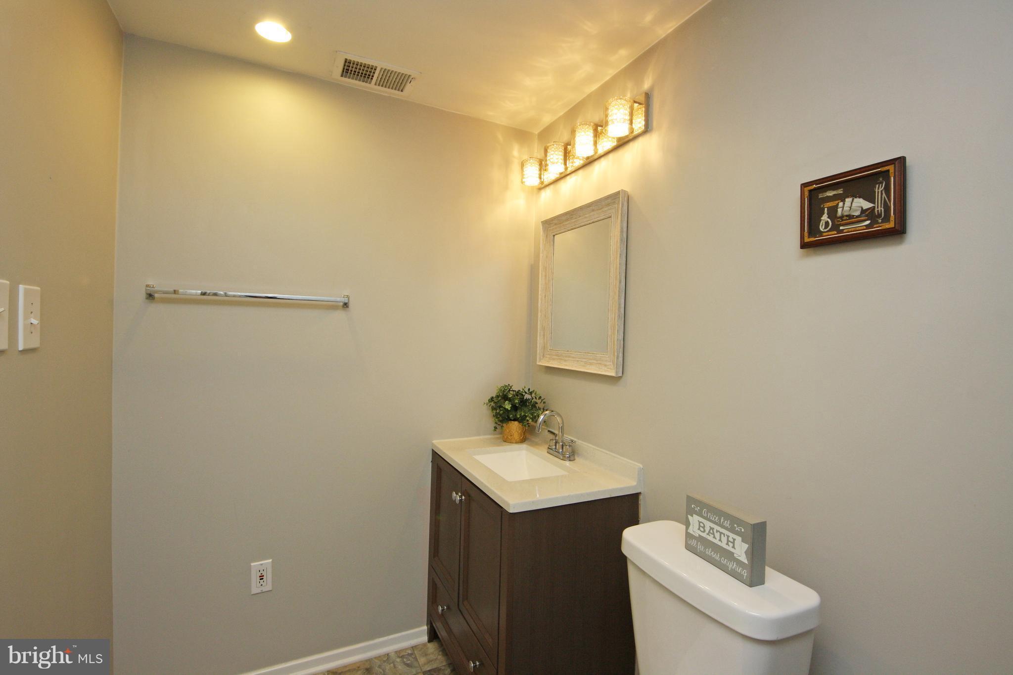 2152 Cedar Barn Way Baltimore, MD 21244 - Photo 26 of 29 a bathroom with a sink mirror and toilet