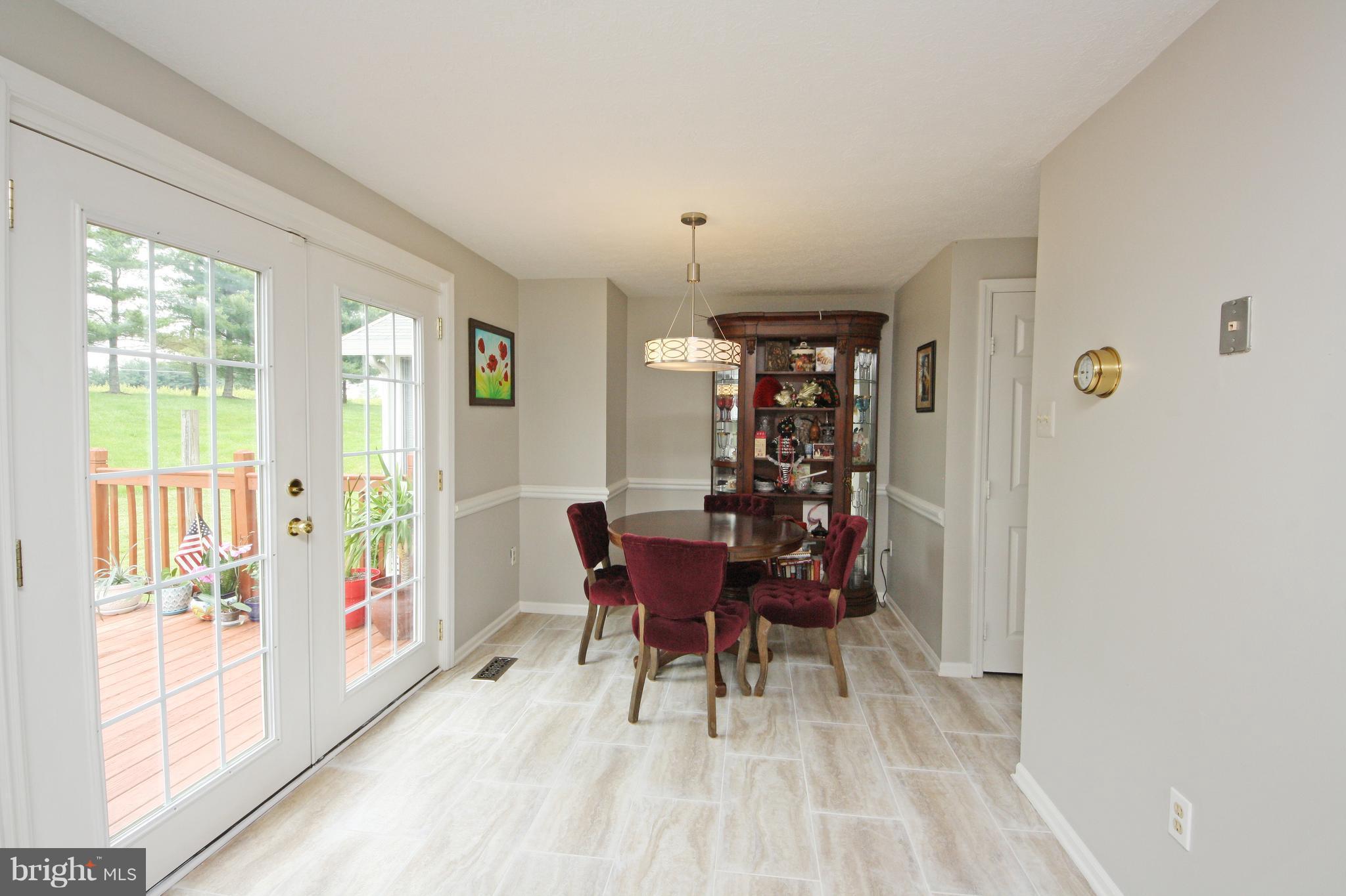 2152 Cedar Barn Way Baltimore, MD 21244 - Photo 5 of 29 a view of a dining room with furniture window and wooden floor