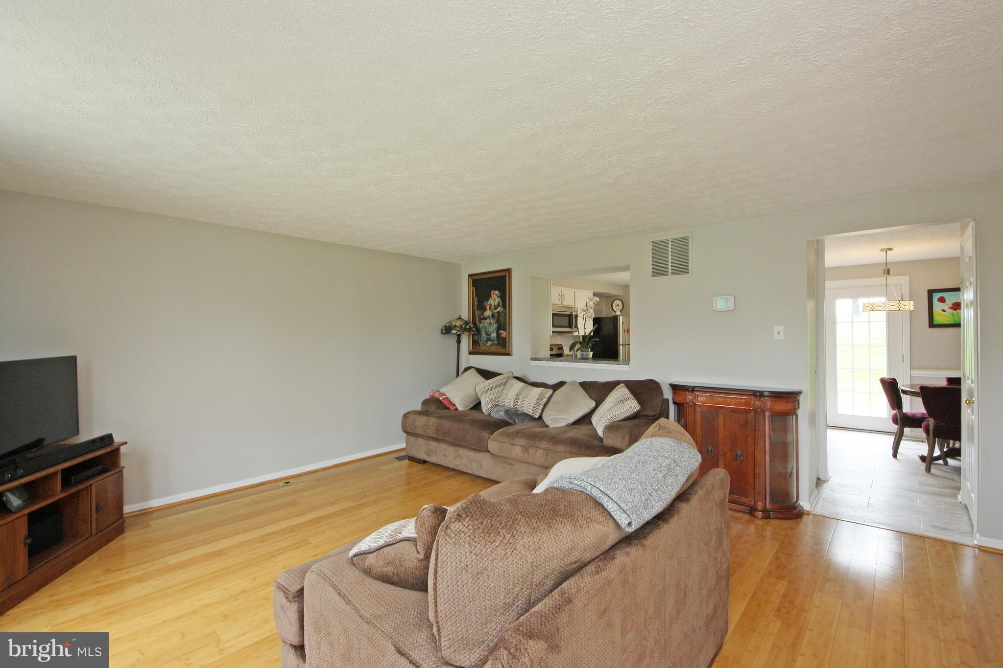2152 Cedar Barn Way Baltimore, MD 21244 - Photo 9 of 29 a living room with furniture and a flat screen tv