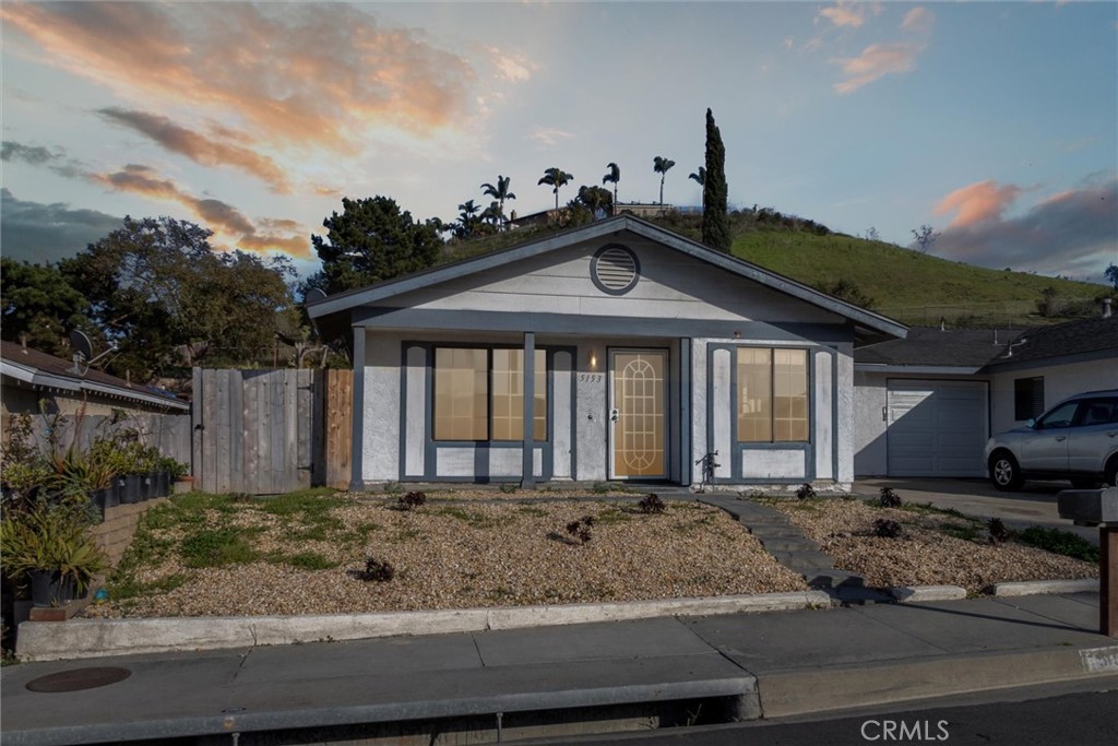 5153 Loma Verde Oceanside, CA 92056 - Photo 1 of 18 a front view of a house with garden