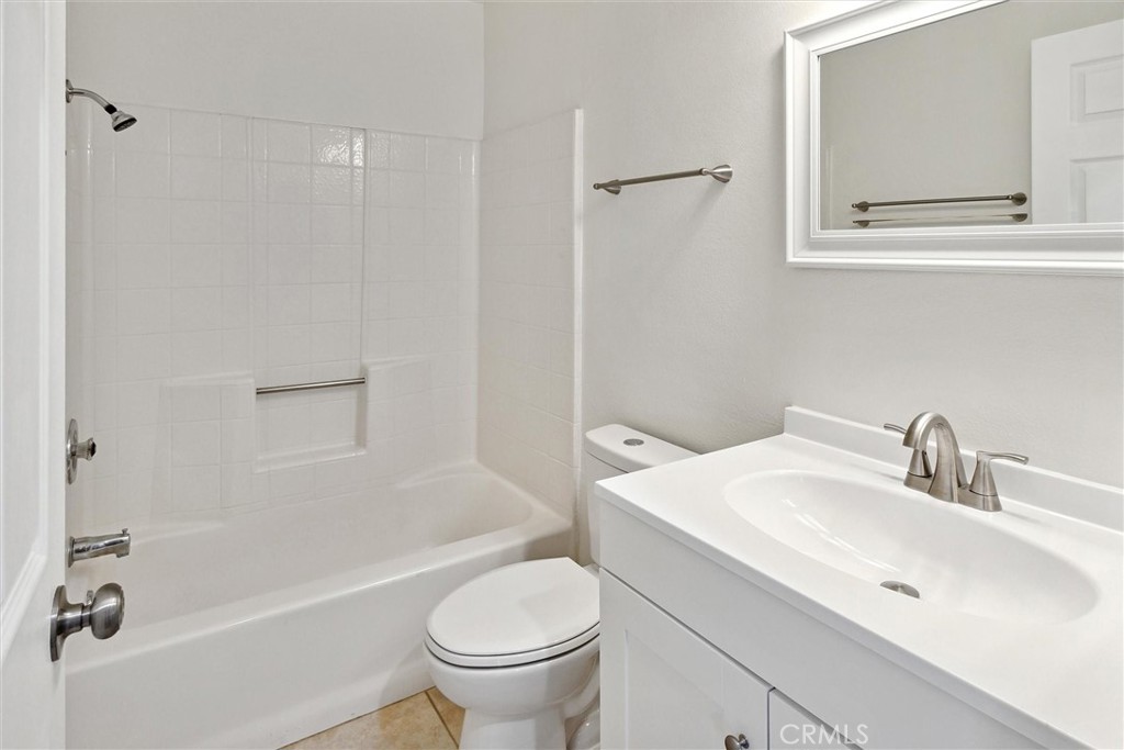5153 Loma Verde Oceanside, CA 92056 - Photo 14 of 18 a bathroom with a sink toilet and shower