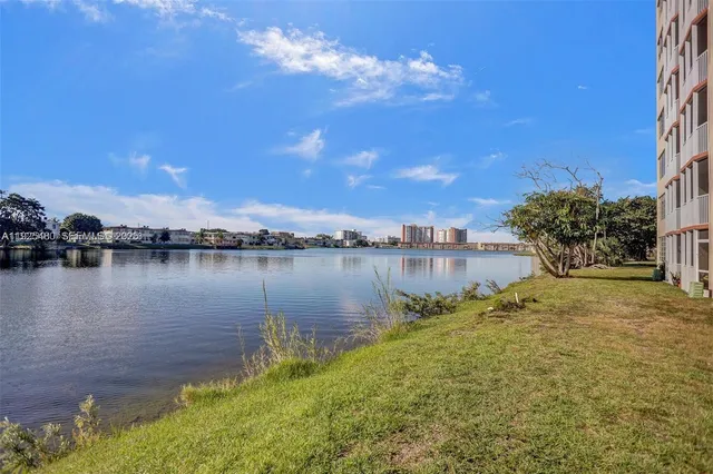 a view of a lake with houses in the background