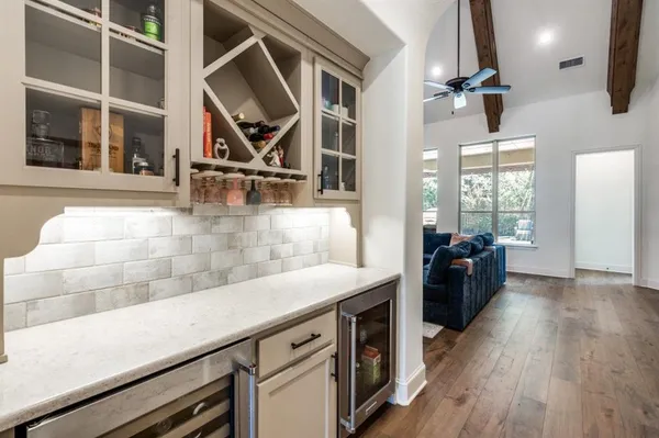 a kitchen with a sink a counter space appliances and cabinets
