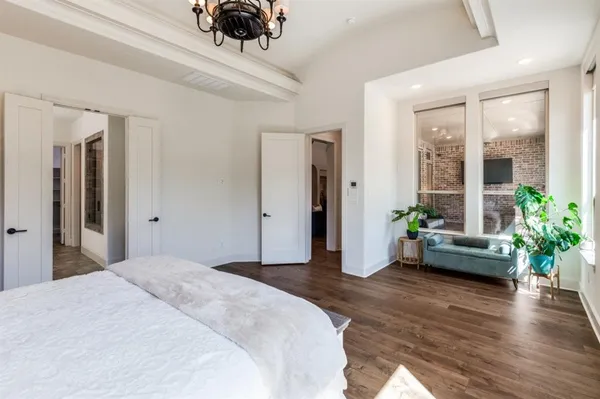 a bedroom with a bed and a large window