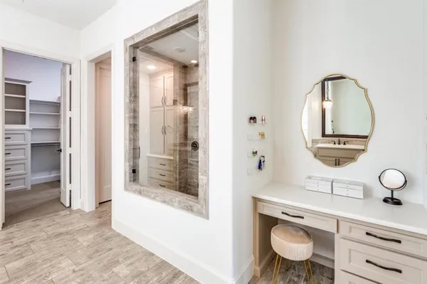 a spacious bathroom with a toilet a sink and a mirror