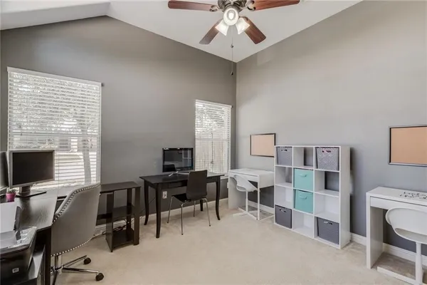 a view of a livingroom with workspace and a window