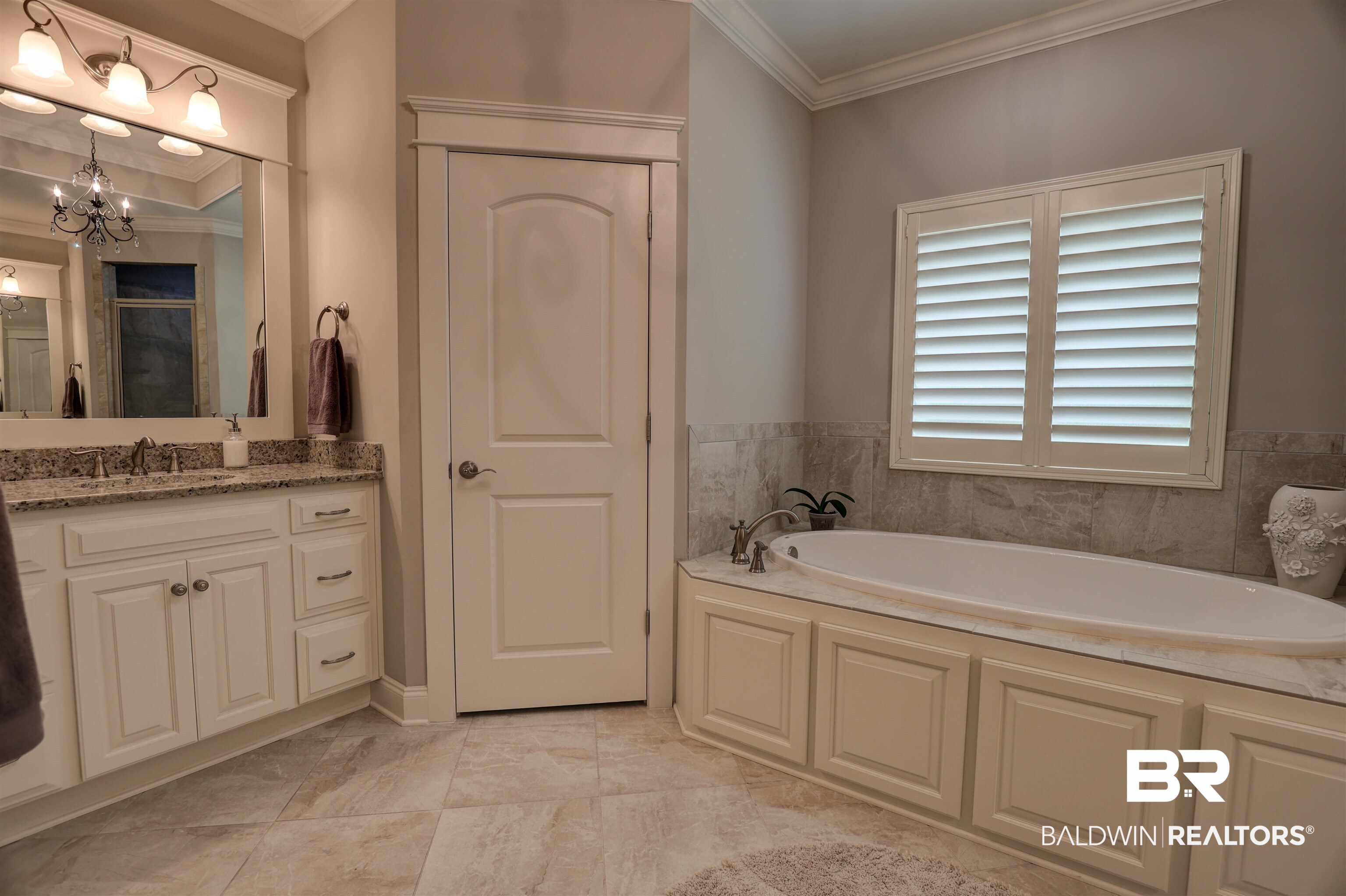 10588 Leesburg Pike Daphne, AL 36526 - Photo 16 of 29 Bathroom with vanity, a chandelier, crown molding, tile patterned flooring, and a bath