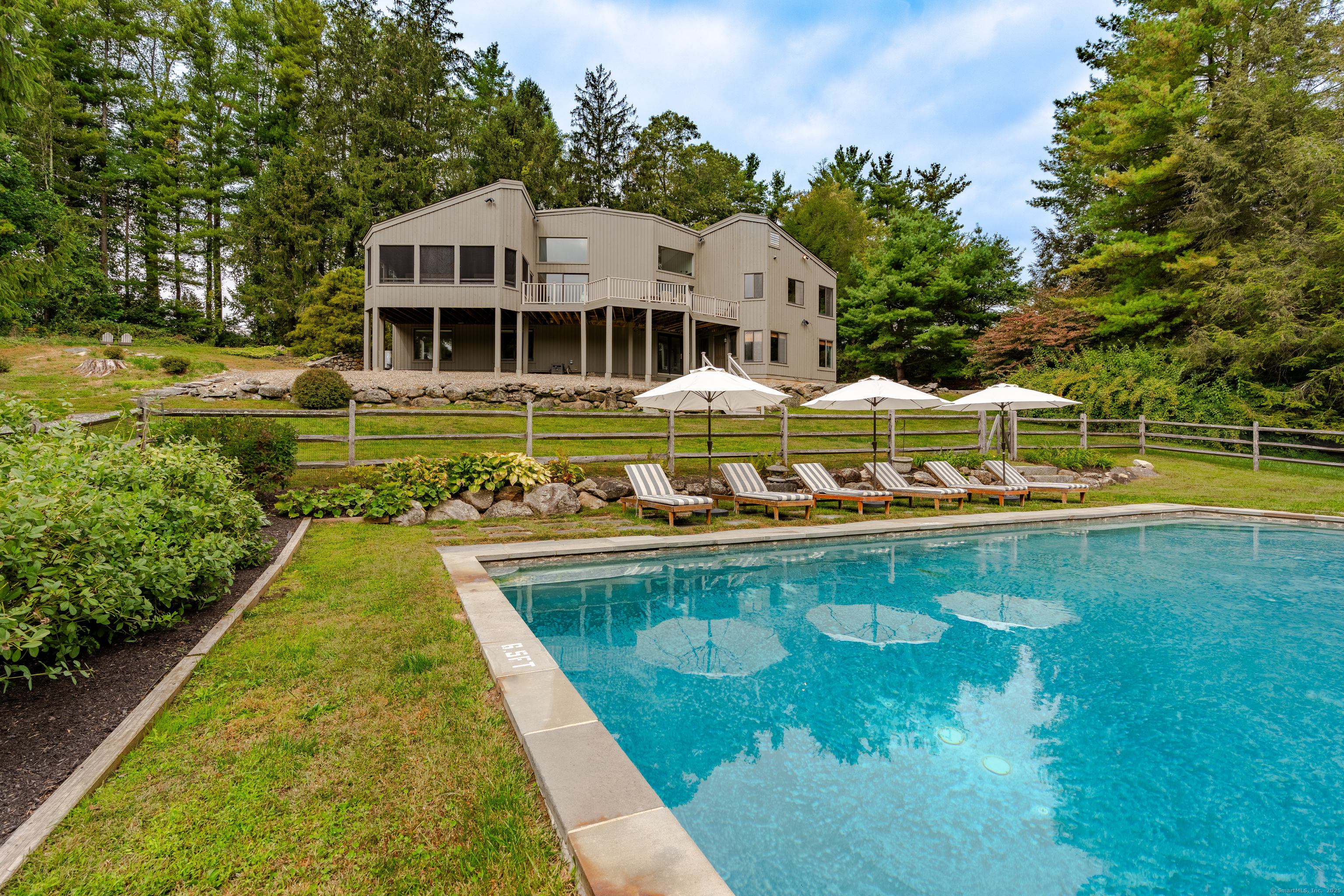 a view of swimming pool with outdoor seating and lake view