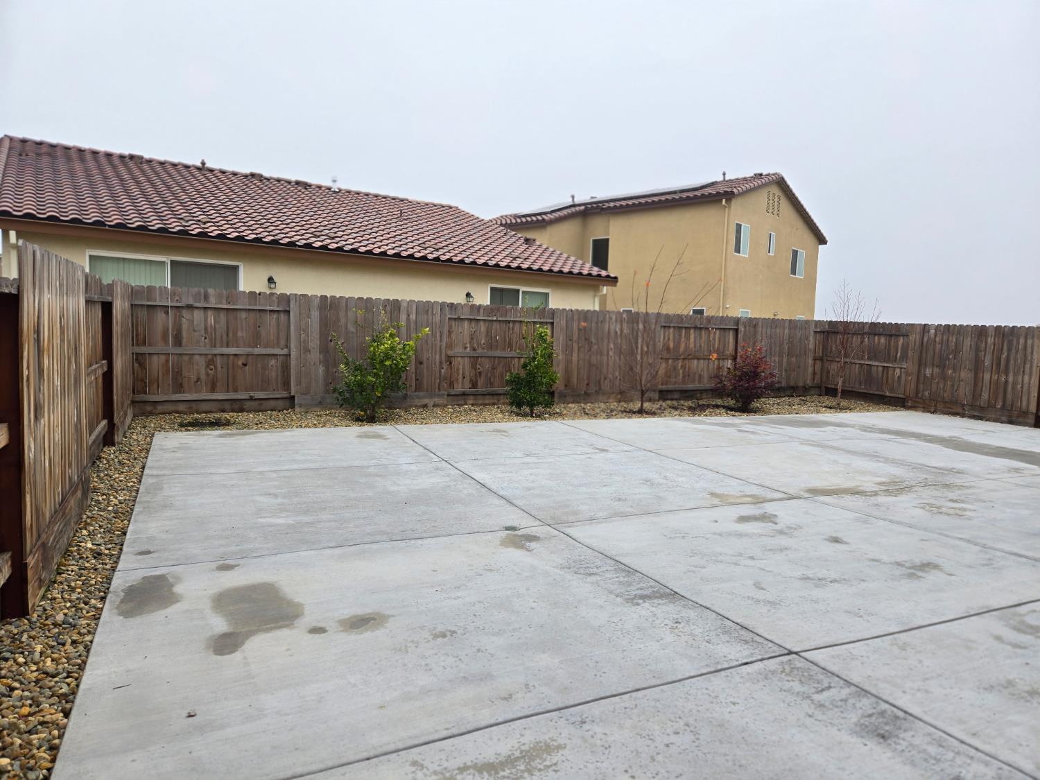 826 Courtney Court Merced, CA 95348 - Photo 7 of 8 a view of a house with a wooden fence