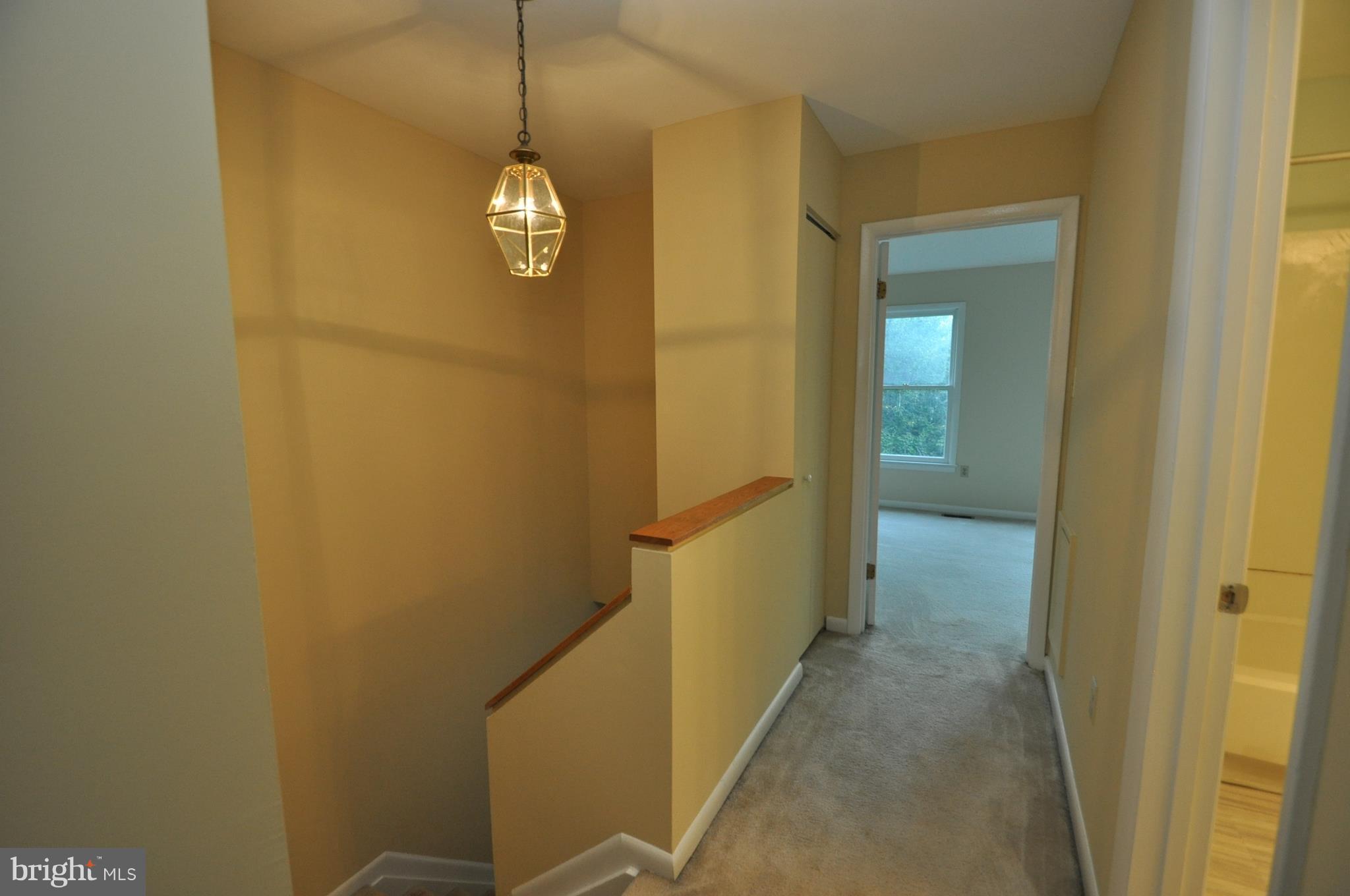 9125 Saffron Lane Silver Spring, MD 20901 - Photo 9 of 18 a view of a hallway with wooden floor