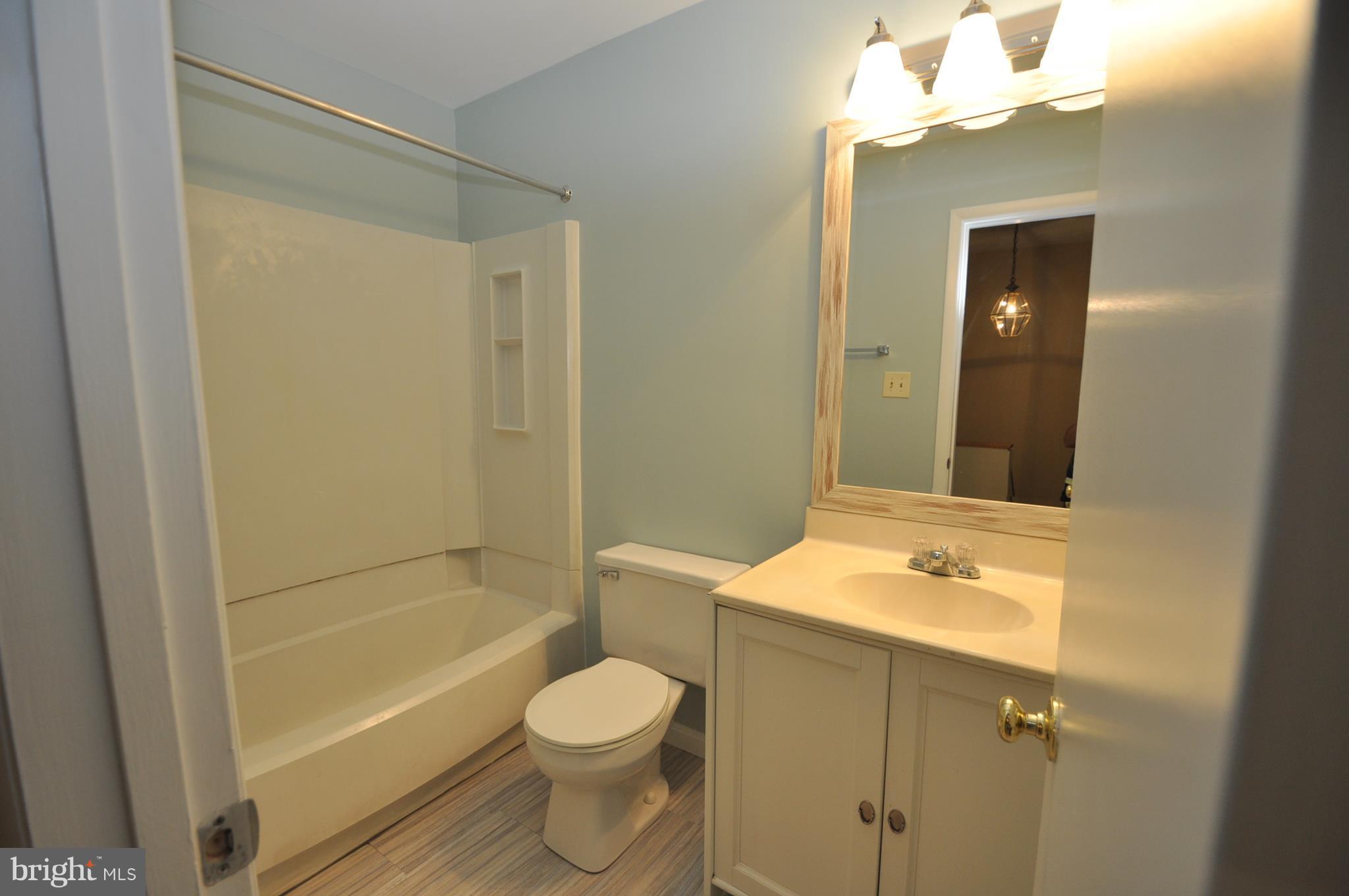9125 Saffron Lane Silver Spring, MD 20901 - Photo 14 of 18 a bathroom with a sink a toilet and shower
