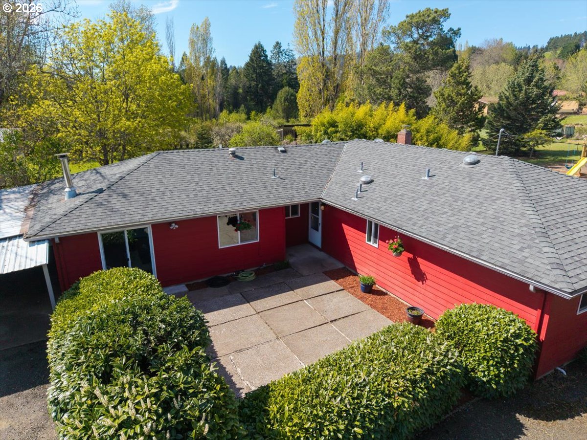2035 Primrose Loop Philomath, OR 97370 - Photo 1 of 48 a view of a red and white house with a yard