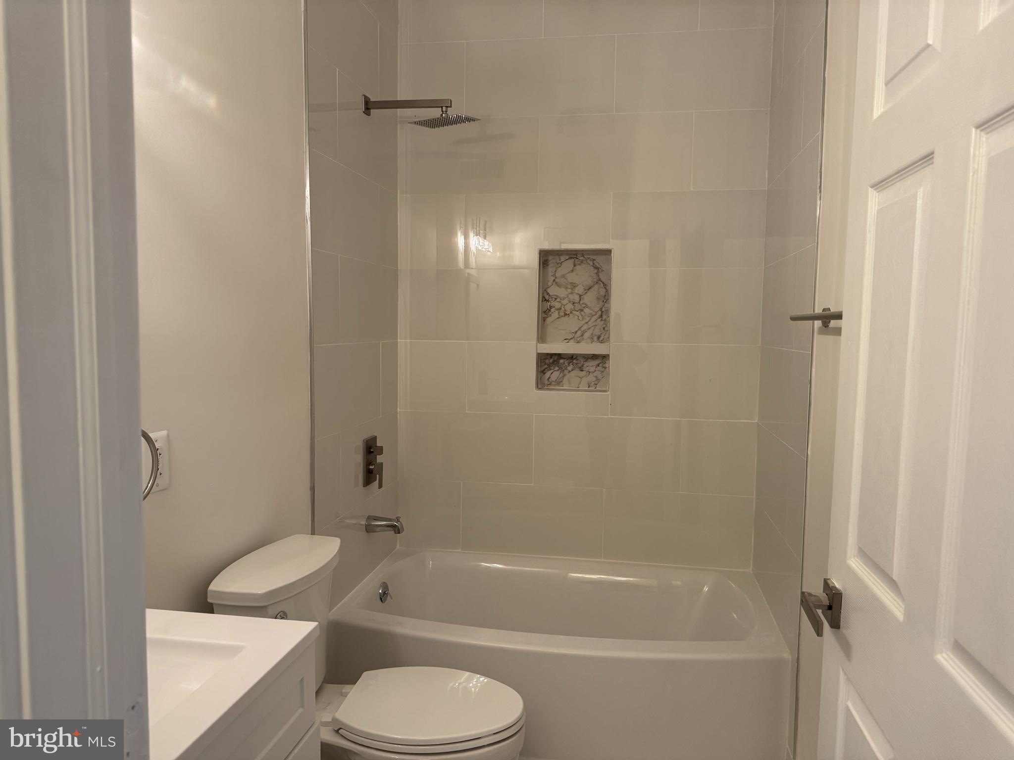 5318 Gay Street Northeast Washington, DC 20019 - Photo 13 of 14 a bathroom with a toilet and a bath tub
