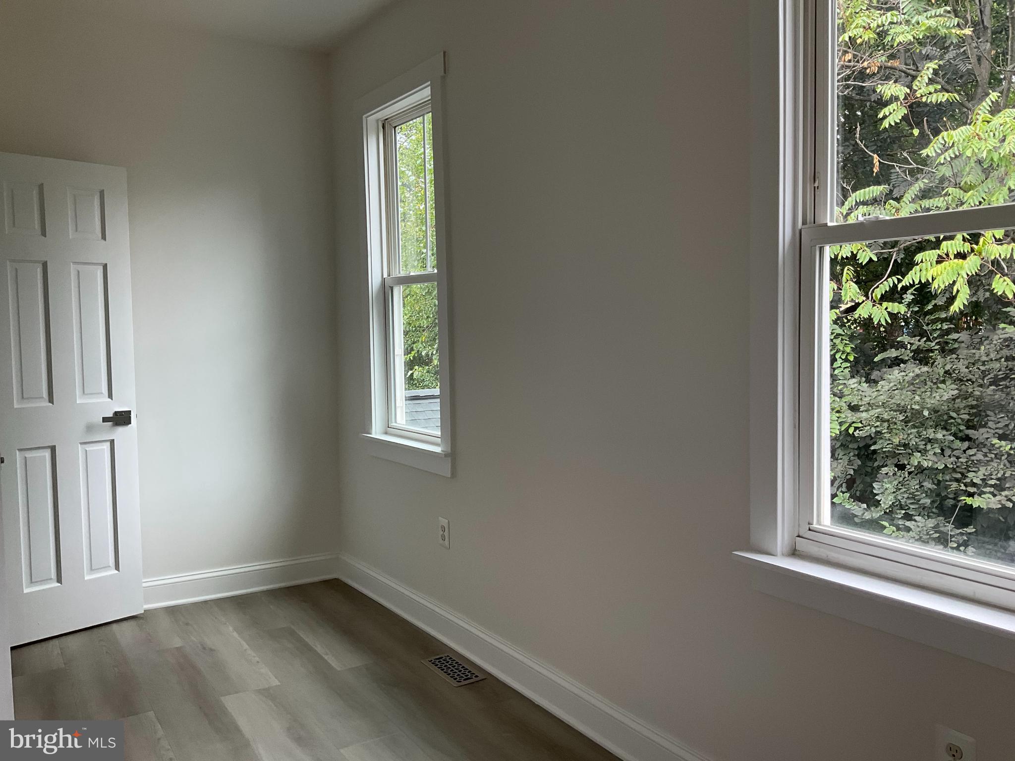5318 Gay Street Northeast Washington, DC 20019 - Photo 5 of 14 an empty room with wooden floor and windows