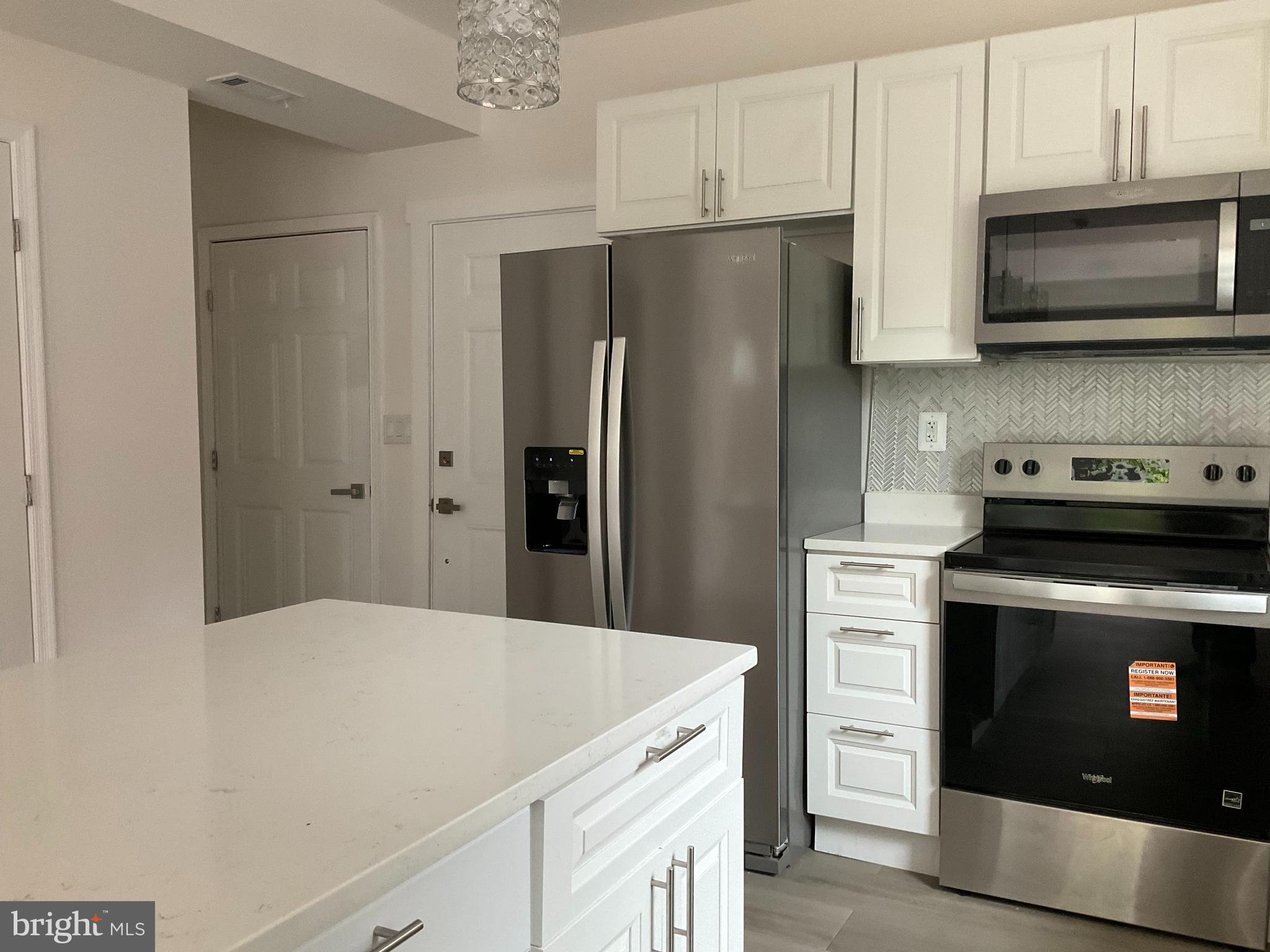 5318 Gay Street Northeast Washington, DC 20019 - Photo 6 of 14 a kitchen with stainless steel appliances a refrigerator stove and microwave