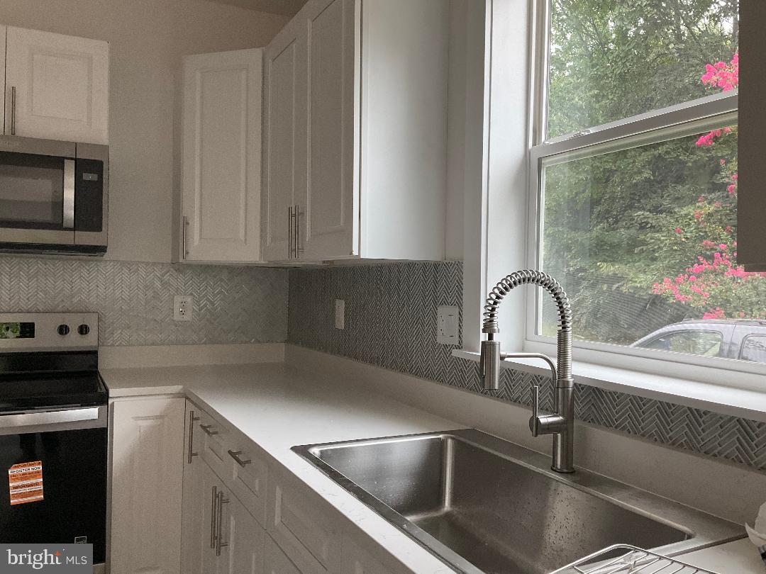 5318 Gay Street Northeast Washington, DC 20019 - Photo 7 of 14 a kitchen with a sink and cabinets