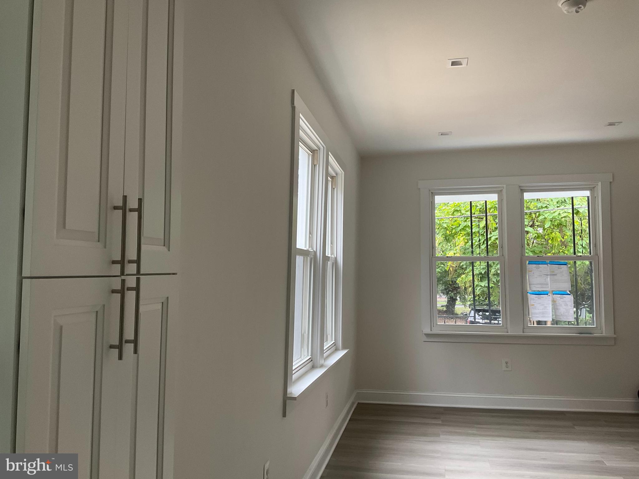 5318 Gay Street Northeast Washington, DC 20019 - Photo 8 of 14 a view of an empty room with wooden floor and a window