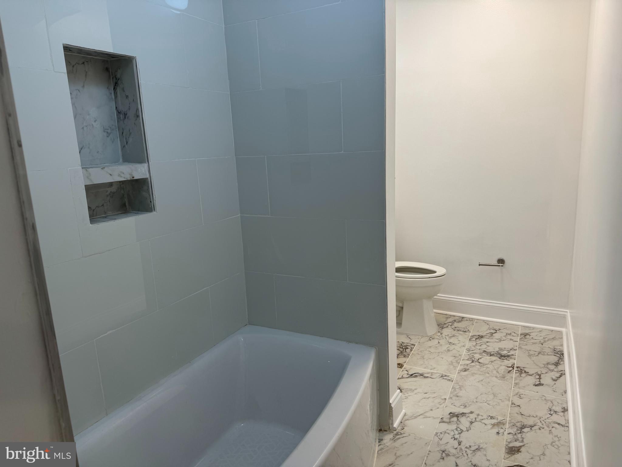 5318 Gay Street Northeast Washington, DC 20019 - Photo 9 of 14 a bathroom with a bathtub and toilet
