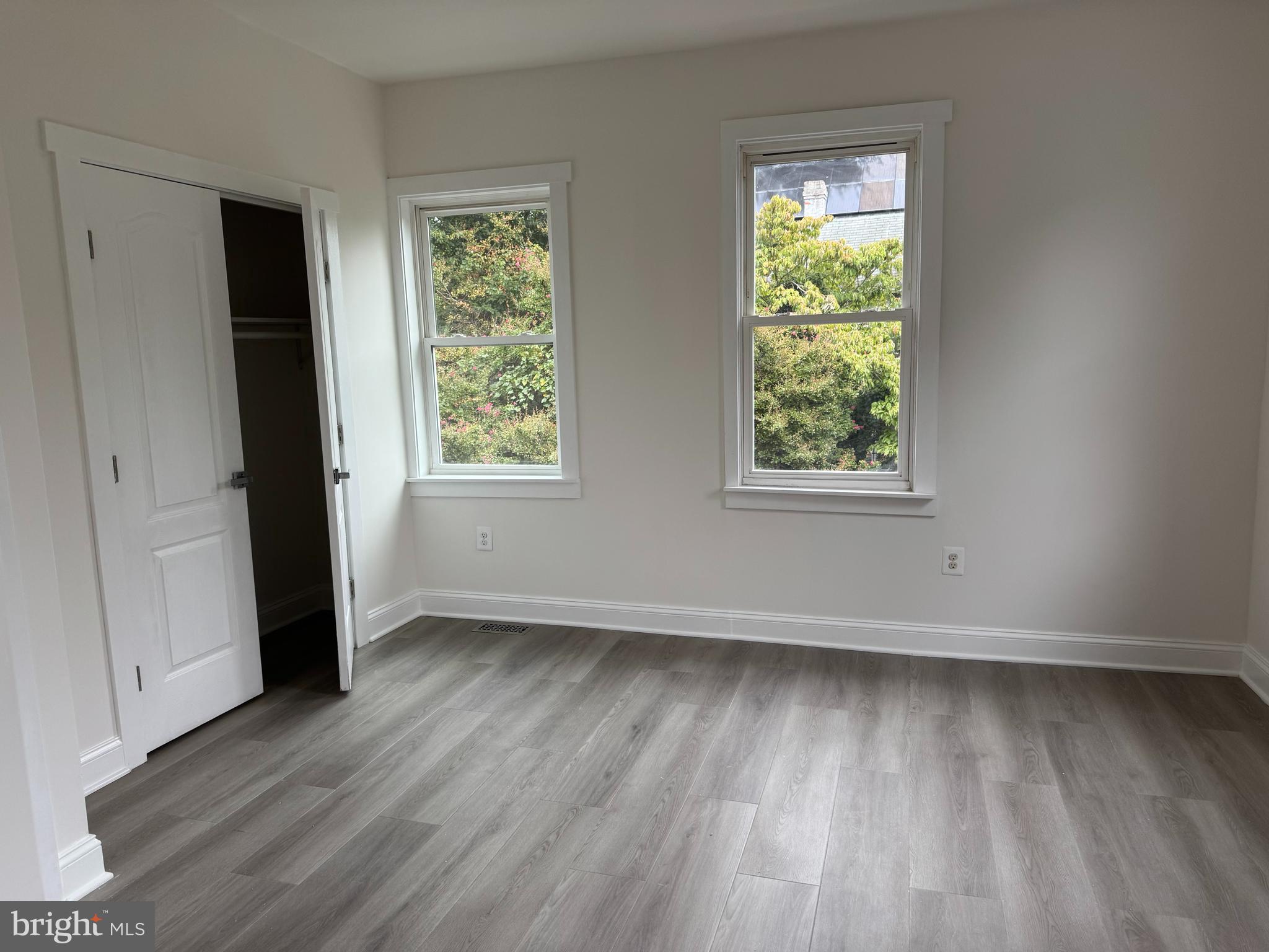 5318 Gay Street Northeast Washington, DC 20019 - Photo 10 of 14 an empty room with wooden floor and windows