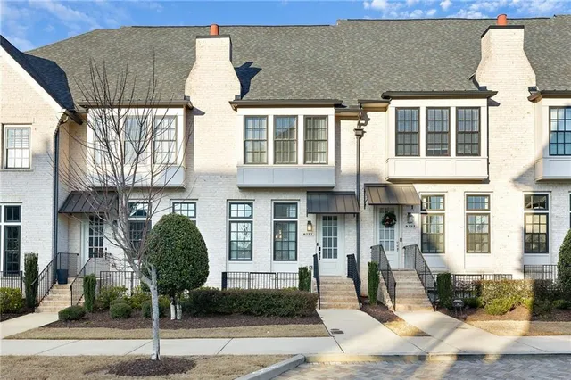 a front view of a building with glass windows and shower