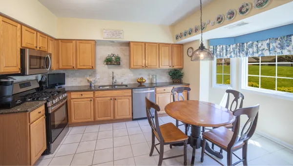 a kitchen with a dining table and chairs
