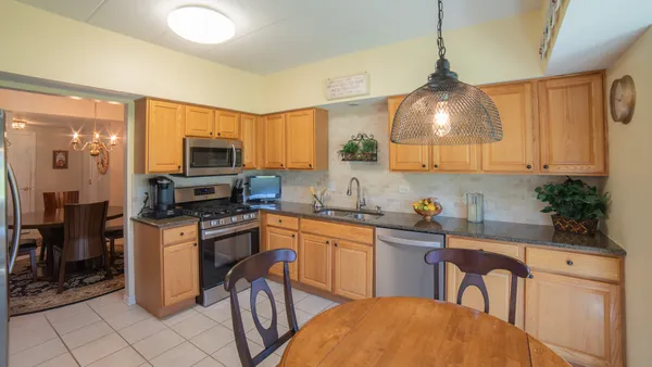 a kitchen with stainless steel appliances a stove a sink refrigerator and microwave