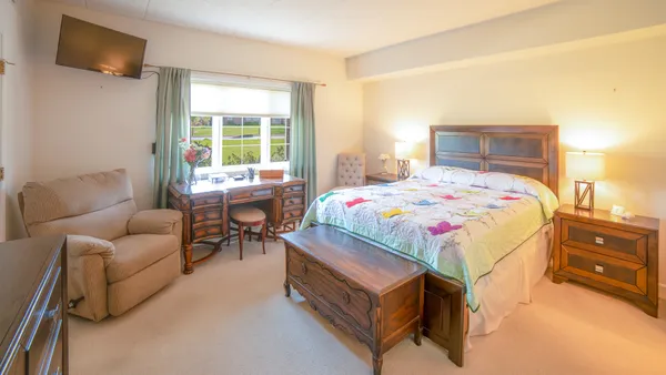a bedroom with a bed and a couch