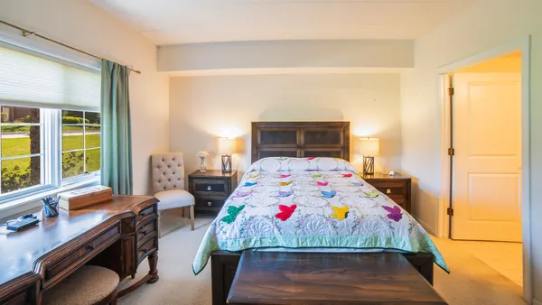 a room that has a bed and a table in it