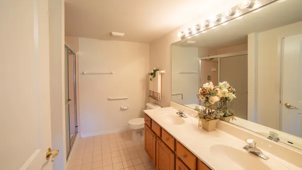 a bathroom with a sink vanity granite and toilet