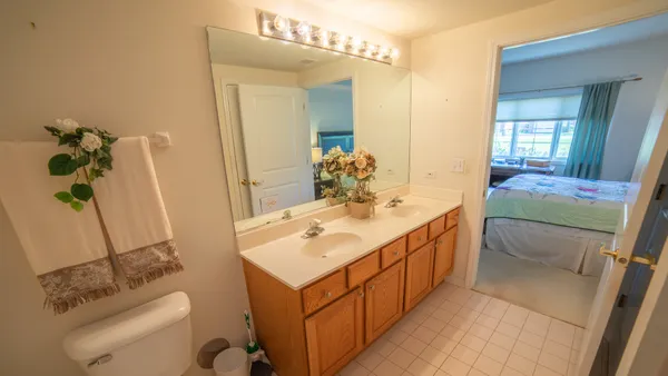 a bathroom with a double vanity sink and a mirror