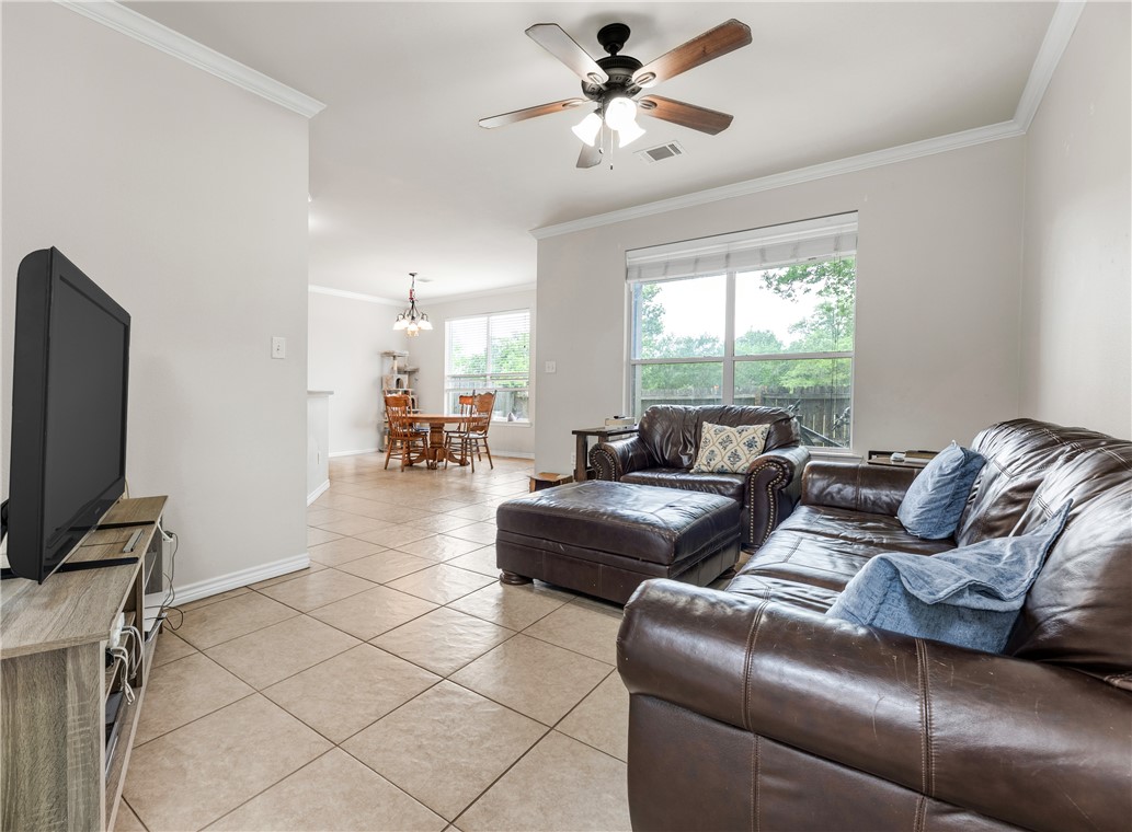 1425 West Villa Maria Road, Unit 1004 Bryan, TX 77801 - Photo 5 of 23 a living room with furniture a ceiling fan and a window