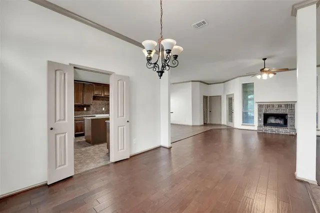 a view of a kitchen with a sink a refrigerator and wooden floor