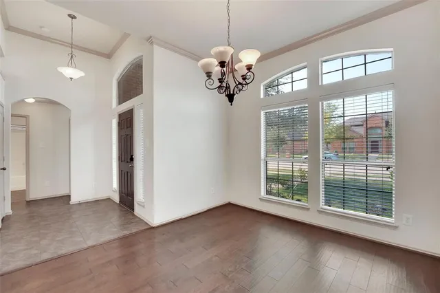 a view of a room with a large window and chandelier