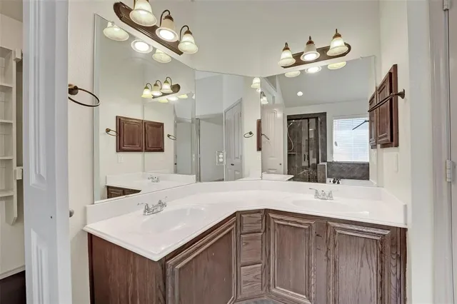 a bathroom with a sink vanity and a mirror