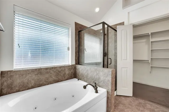 a bathroom with a bathtub and a shower