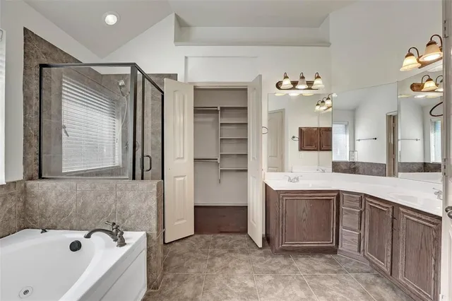 a bathroom with a bathtub sink and mirror