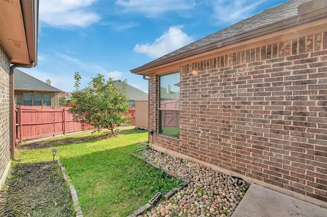 a view of house with backyard