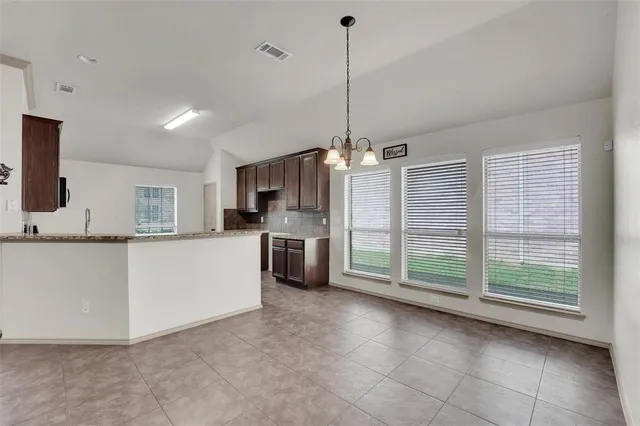 a view of a kitchen with a sink and microwave