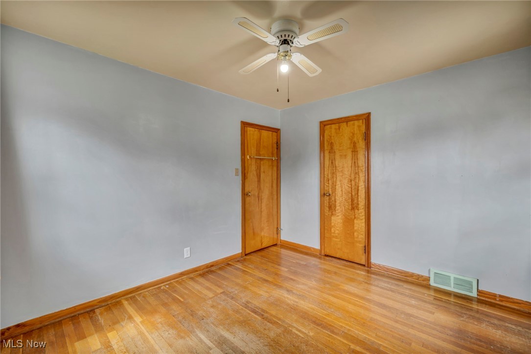 367 High Grove Boulevard Akron, OH 44312 - Photo 22 of 46 Empty room featuring light wood-type flooring, baseboards, visible vents, and ceiling fan