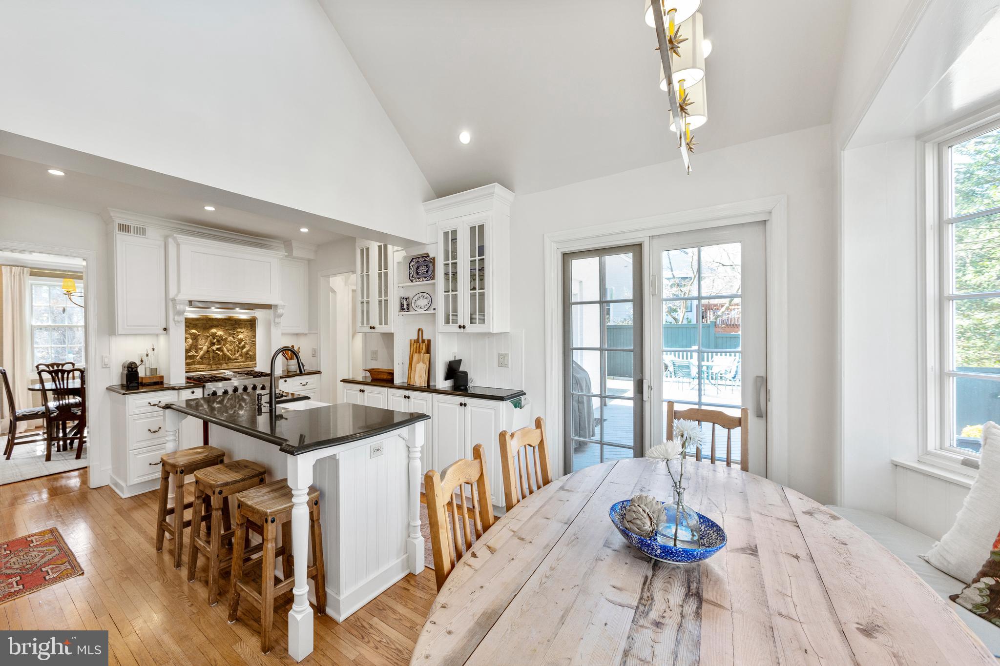 3303 Rolling Road Chevy Chase, MD 20815 - Photo 12 of 51 a view of a dining room with furniture a chandelier and wooden floor